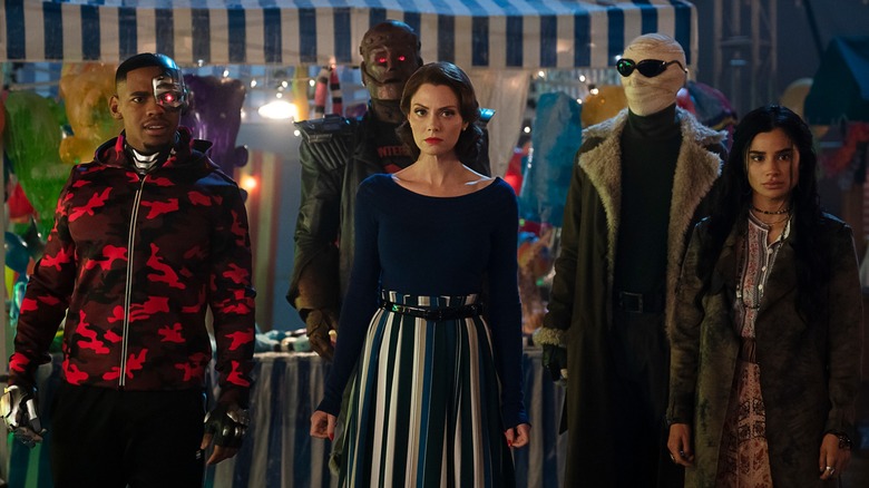Cyborg, Robotman, Elasti-Girl, Mr. Negative and Crazy Jane in civilian clothes at a carnival in "Doom Patrol"