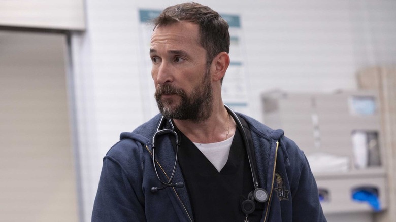 Noah Wyle as Dr. Robby Robinavitch looking anxiously to his right in The Pitt