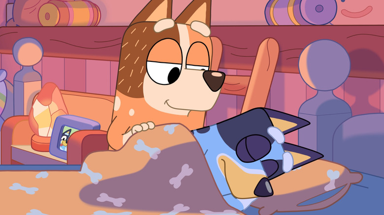 Chilli tucking Bandit into bed on Bluey