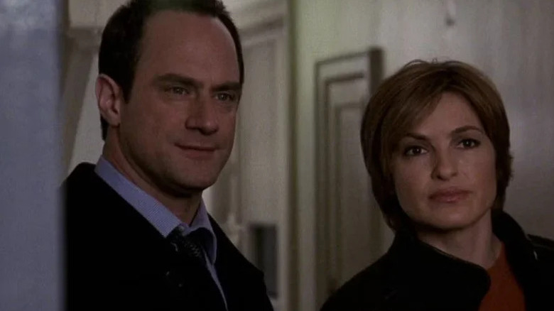 Elliot Stabler (Christopher Meloni) and Olivia Benson (Mariska Hargitay) stand together in a hallway in Law & Order: Special Victims Unit