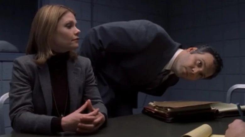 Kathryn Erbe (Alexandra Eames) glances at Bobby Goren (Vincent D'Onofrio) looking sideways at a suspect in Law & Order: Criminal Intent