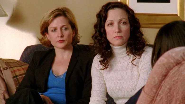 Kelly Gaffney (Amy Carlson) and Tracey Kibre (Bebe Neuwirth) sit together on a couch in Law & Order: Trial by Jury