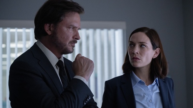 Henry Graff (Aden Young) and Frankie Bateman (Kathleen Munroe) glance at each other in Law & Order Toronto: Criminal Intent