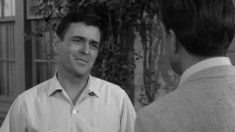 Johnson speaks to someone outside a house in "The Twilight Zone" (1959)