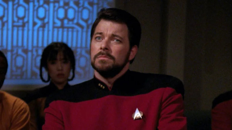 Will Riker (Jonathan Frakes) sits discerningly in a courtroom in Star Trek: The Next Generation