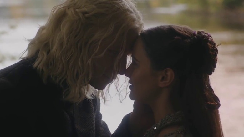 Wilf Scolding and Aisling Franciosi as Rhaegar and Lyanna embracing by a river in Game of Thrones