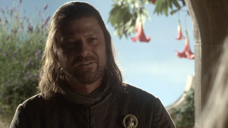 Sean Bean as Ned Stark standing in a doorway in Game of Thrones