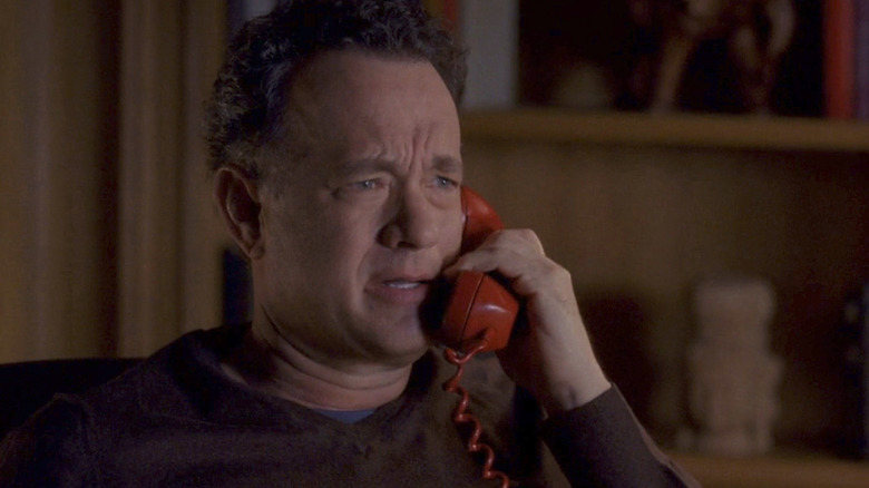Tom Hanks talking on a red telephone in 30 Rock