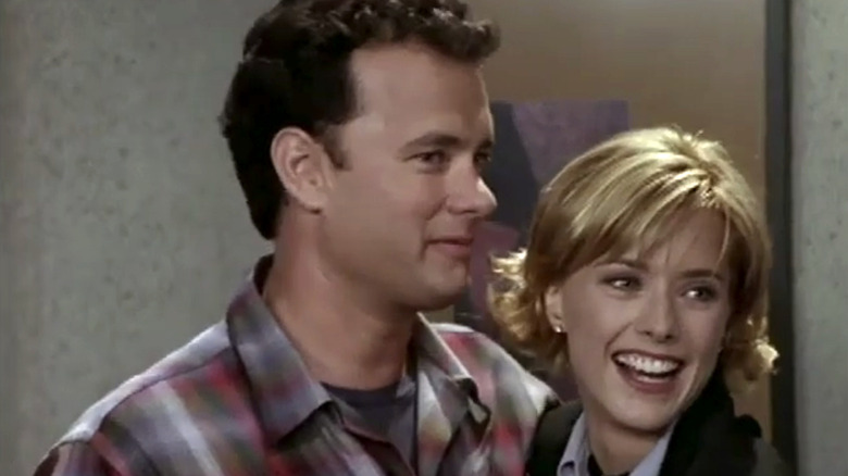 Tom Hanks standing next to Nora in The Naked Truth
