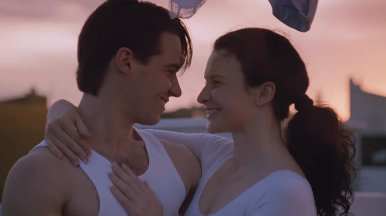 characters from the movie Strictly Ballroom smiling mid-dance.