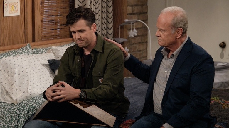 Jack Cutmore-Scott as Freddy getting a pat on the back from Kelsey Grammer as Dr. Frasier Crane in Frasier (2023)