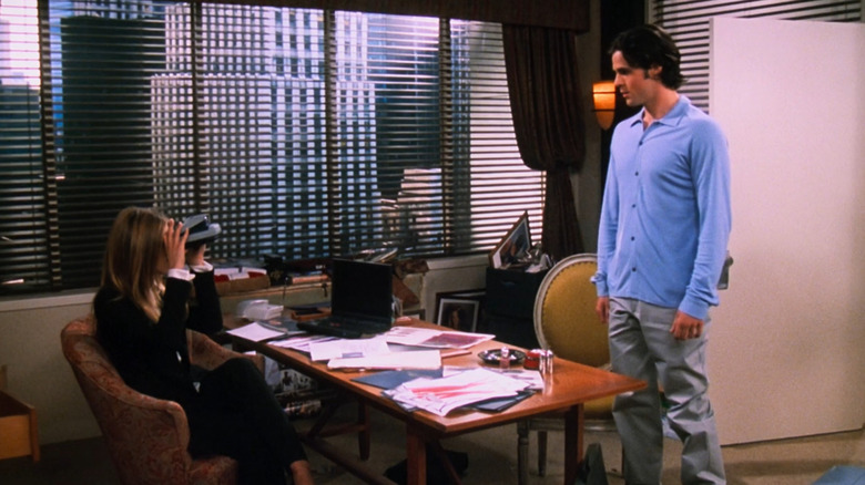 Rachel takes Polaroid of Tag in interview