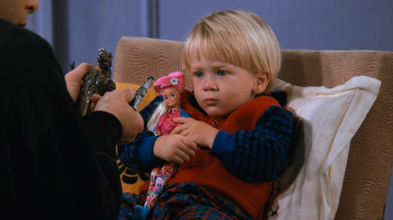 Young Ben holds Barbie doll