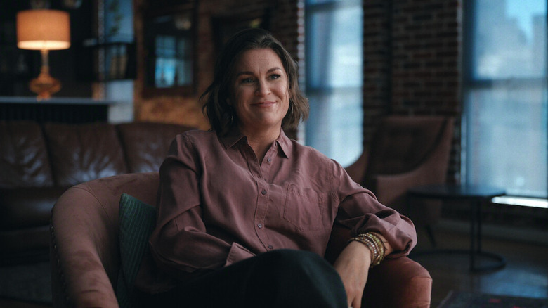 Mia Perry Bowick smiling and sitting in an armchair