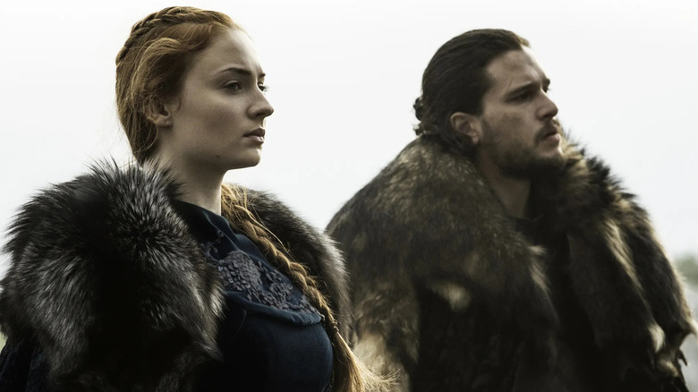 Sophie Turner and Kit Harington as Sansa and Jon Snow next to each other on horseback in Game of Thrones