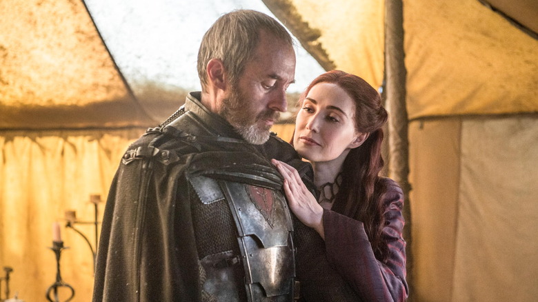 Carice van Houten as Melisandre caressing the armor of Stephen Dillane as Stannis Baratheon in Game of Thrones