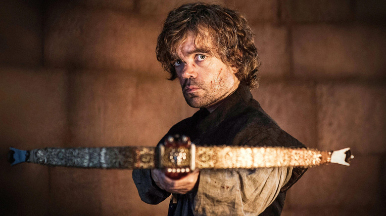 Peter Dinklage as Tyrion holding a crossbow in Game of Thrones