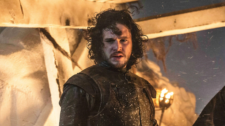 Kit Harington as Jon Snow looking down off the Wall in Game of Thrones