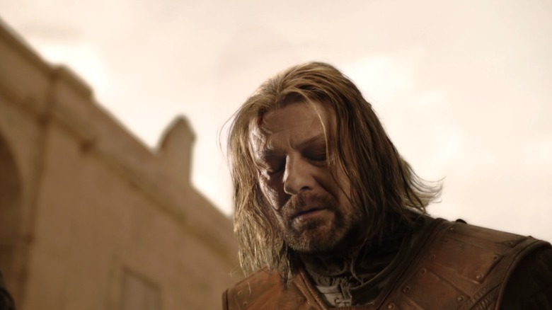 Ned kneeling with his eyes closed on Game of Thrones S1E9