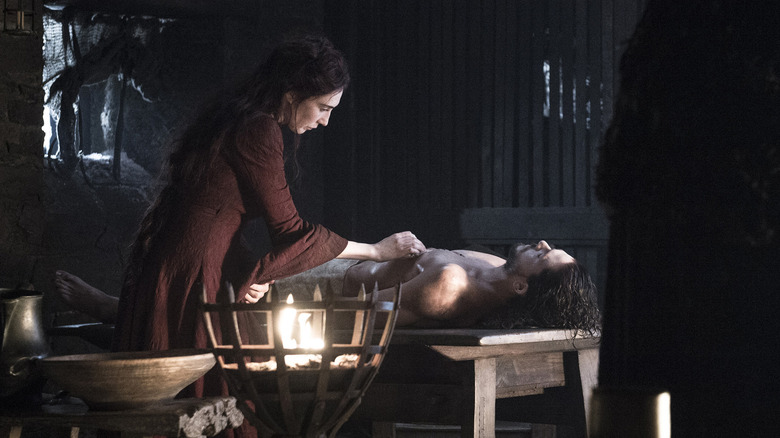Carice Van Houten's Melisandre treating Kit Harington's Jon Snow on Game of Thrones
