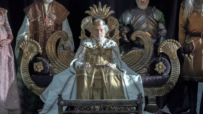 Michael Carter as Jaehaerys I sitting on his throne in House of the Dragon