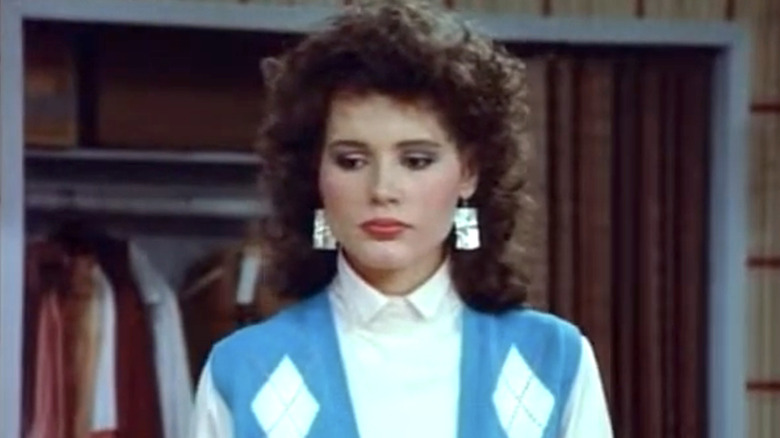 Wendy Killian in a blue and white sweater, looking down