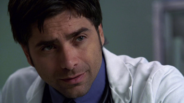 Tony Gates (John Stamos) hunched over on "ER"