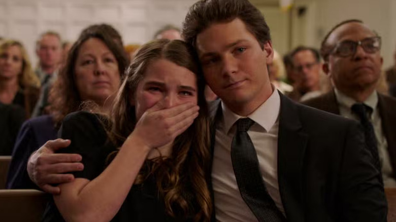 George holds Missy as she covers her mouth and cries with tears in her eyes inside a church on Young Sheldon (2017-2024)