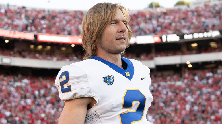 Chad Powers (Glen Powell) dons his football jersey during a packed game in "Chad Powers"