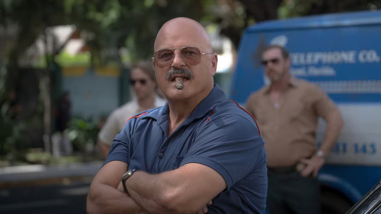Michael Chiklis as Agent Zulio, smoking a cigar in Hotel Cocaine.