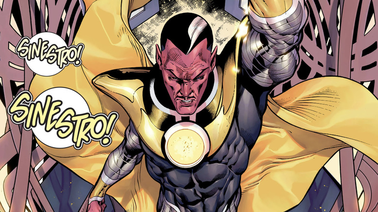 A pink skinned alien has black hair with a white stripe in it. He's wearing a dark silver and gray uniform with large yellow metallic shoulder armor that extends across his chest as well as descending into a large yellow cape. There are two speech bubbles with yellow text which both read "SINESTRO!"
