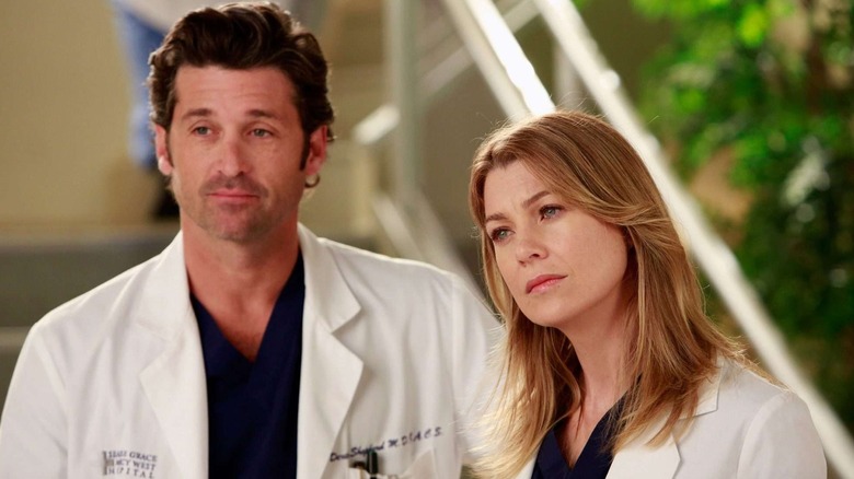 Derek and Meredith standing next to each other on "Grey's Anatomy"