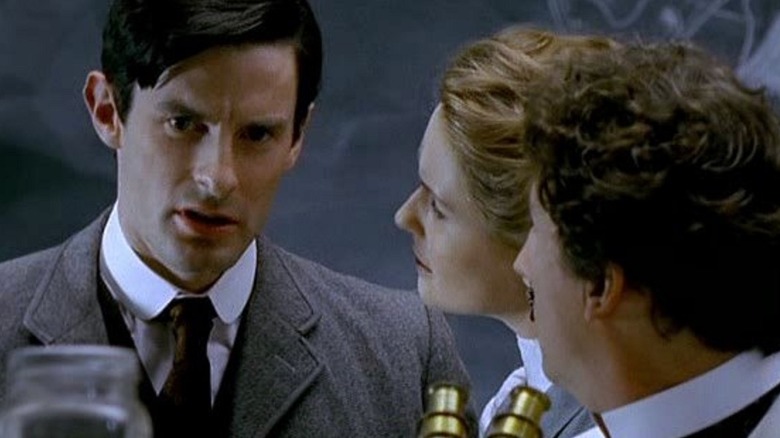 H.G. Wells in a lab with Jane Robbins and a scientist