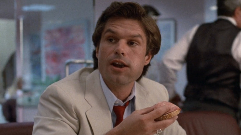 Michael Kuzak eating a sandwich while talking