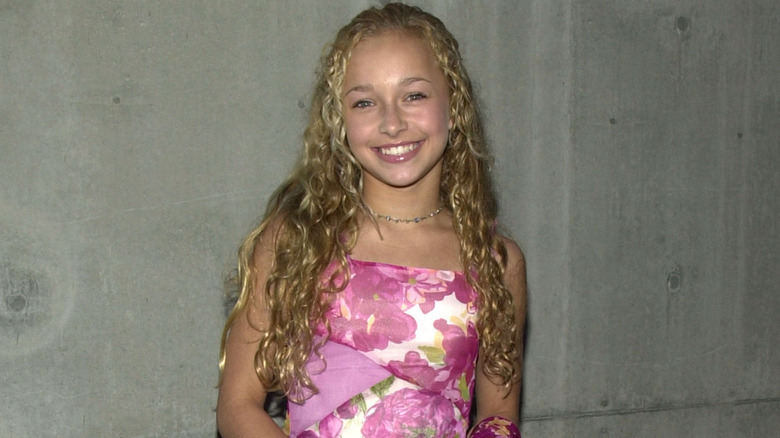 Young Hayden Panettiere wearing a pink dress and crimped hair