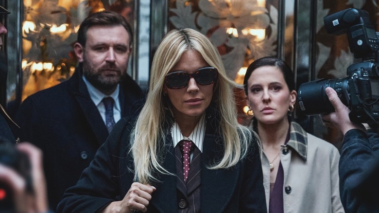 James Mcardle as Byrne, Sienna Miller as Carla Duval, and Phoebe Fox as Taylor getting photographed by paparazzi in a scene from "War."