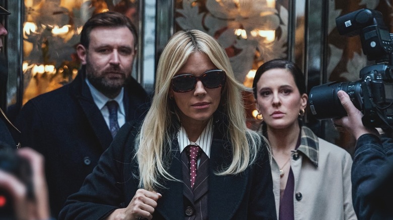 James Mcardle as Byrne, Sienna Miller as Carla Duval, and Phoebe Fox as Taylor getting photographed by paparazzi in a scene from "War."