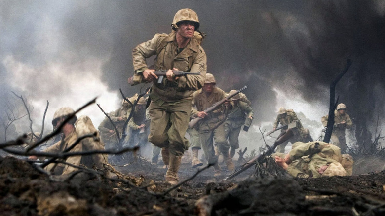 Soldiers run through fire during WWII.