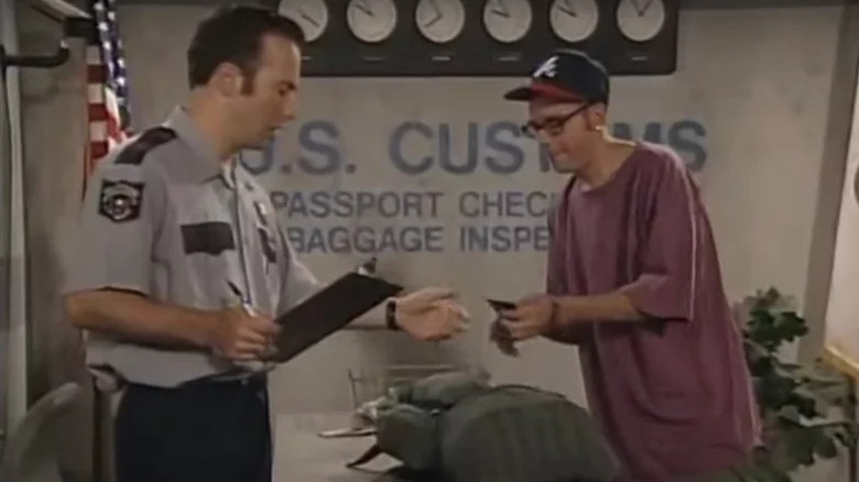A customs officer (Bob Odenkirk) checks a passport from a man (David Cross) in Mr. Show with Bob and David