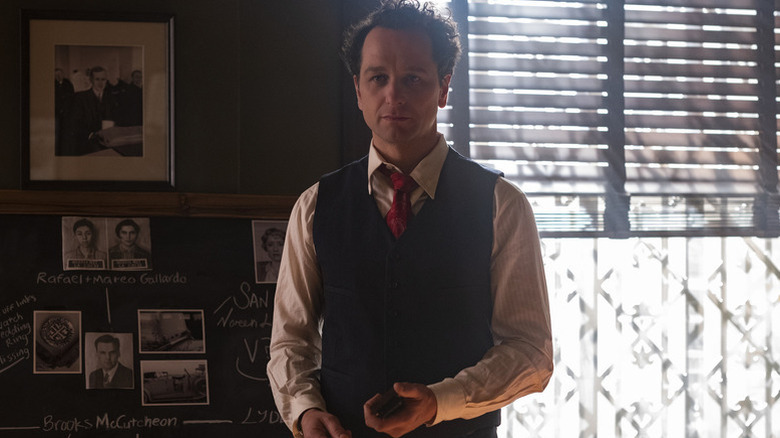 Perry Mason (Matthew Rhys) stands by a window in his office in Perry Mason (2020)