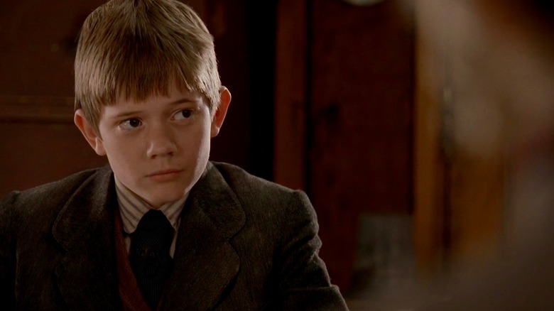 William Bullock seated and looking on