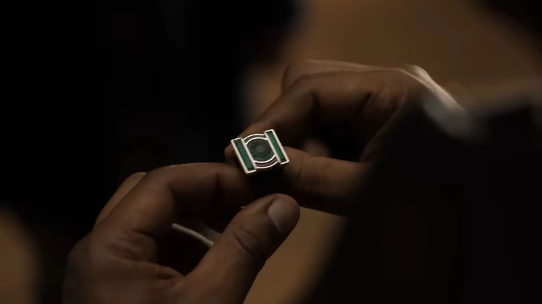 The hands of John Stewart (Aaron Pierre) holding Hal Jordan's Green Lantern ring in "Lanterns"