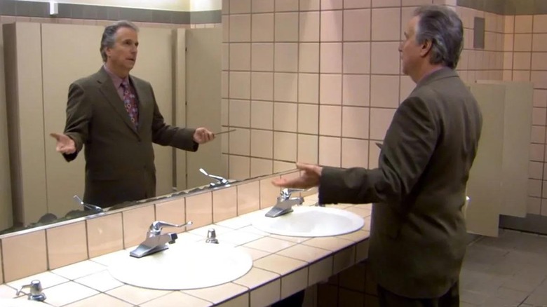 Barry Zuckercorn doing Fonz move with comb in bathroom mirror
