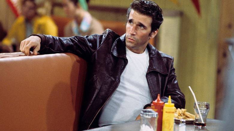 The Fonz lounging at a table in a diner on the classic ABC sitcom Happy Days.