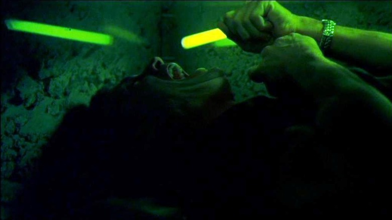 Nick Stokes screams while trapped inside a glass coffin surrounded by green light in "CSI"