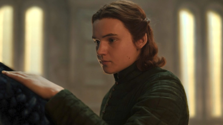 Benjamin Evan Ainsworth as Daeron Targaryen petting his dragon Tessarion in House of the Dragon