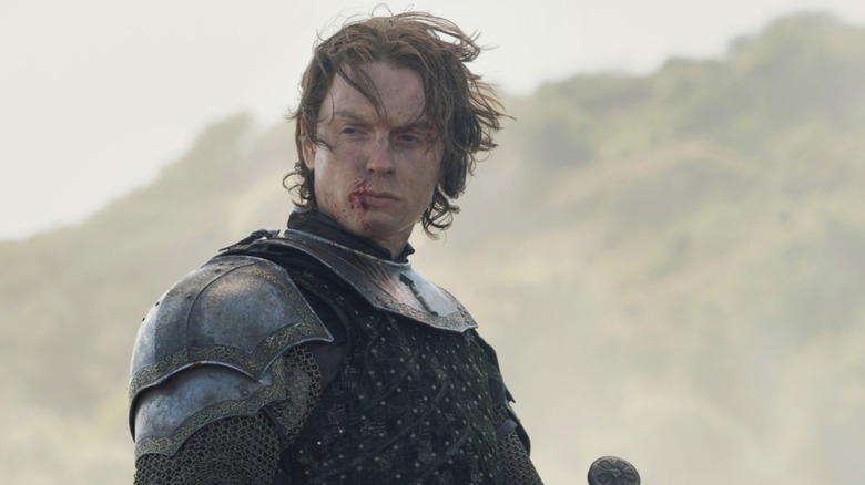 Freddie Fox as Gwayne Hightower looking worn from battle with wind in his hair in House of the Dragon