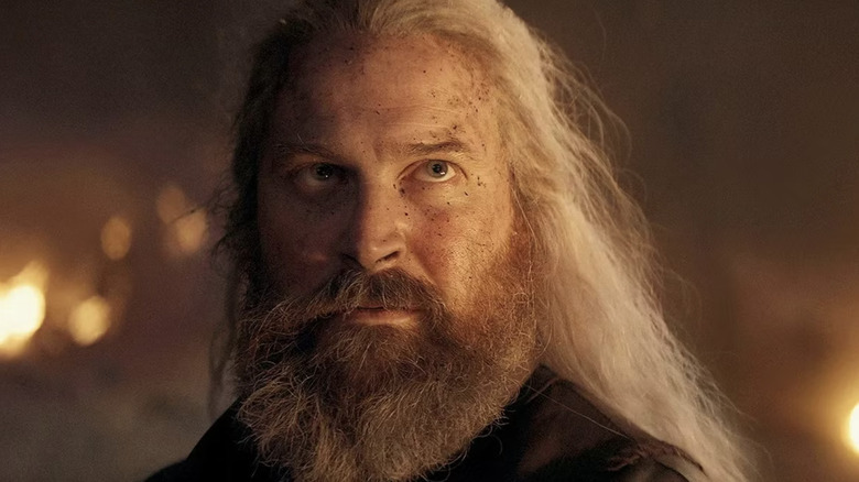 Kieran Bew as Hugh Hammer looking up at Vermithor in House of the Dragon