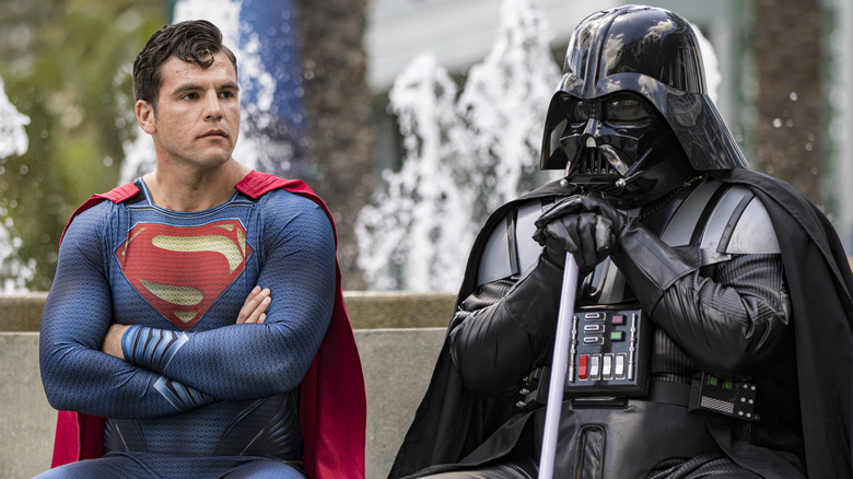 Superman and Darth Vader cosplayers sitting next to one another is the closest thing we'll get to a DC and "Star Wars" crossover