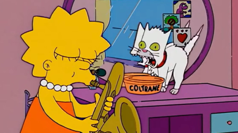 Lisa grabs her saxophone as Coltrane the kitten leans on his food bowl on The Simpsons.